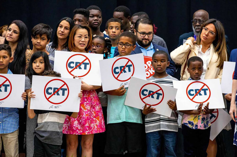 Schoolchildren holding signs against the concept of critical race theory