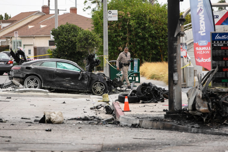 Officials investigate a car crash