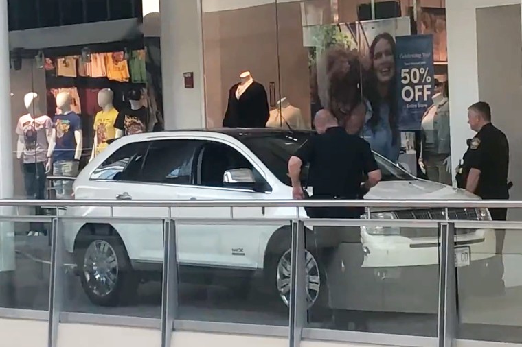 Police investigate a SUV vehicle accident inside South Shore Plaza mall in Braintree, Mass., on Aug. 18, 2022.