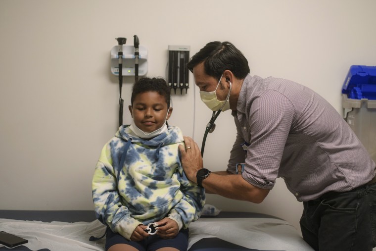 Dr. Sydney Leibel, who treats children with severe asthma at the Rady Children's Hospital in San Diego, checks Ezra Larios' breathing.
