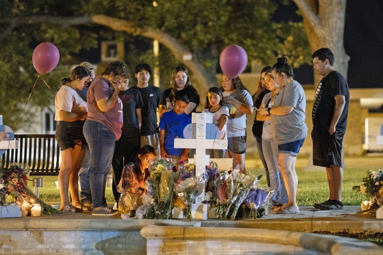 Image: Family and relations of Alexandria Rubio, 10, gather at a makeshift memorial to the victim of the Robb Elementary mass shooting, in the town square of Uvalde, Texas, May 27, 2022.