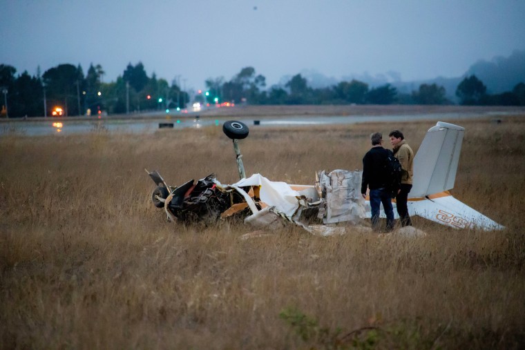 Investigators work at the crash site after two planes collided in Watsonville, Calif., on Aug. 18, 2022.