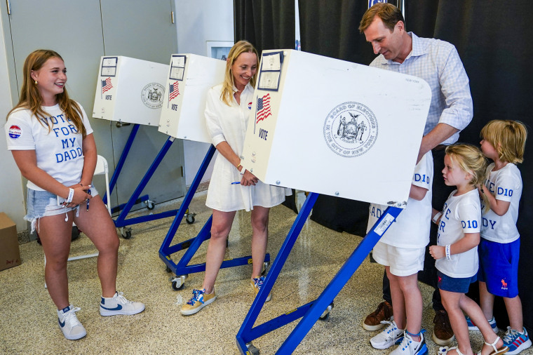 Attorney Dan Goldman, right, is joined by his family as he votes early in the Democratic primary election on Aug. 17, 2022, in New York.
