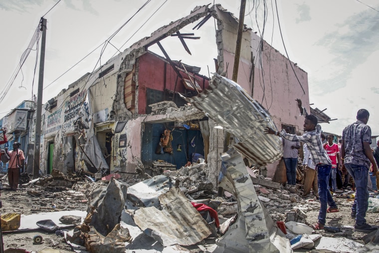 People clear wreckage at the scene, after gunmen stormed a hotel in Mogadishu, Somalia, on Aug. 21, 2022.