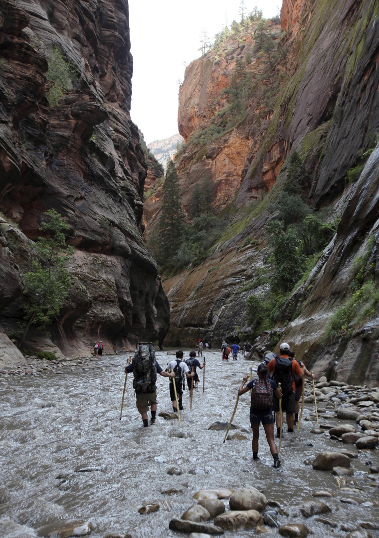 Hikers wade through the Virgin River along the Narrows in Zion National Park, Utah, in 2009.