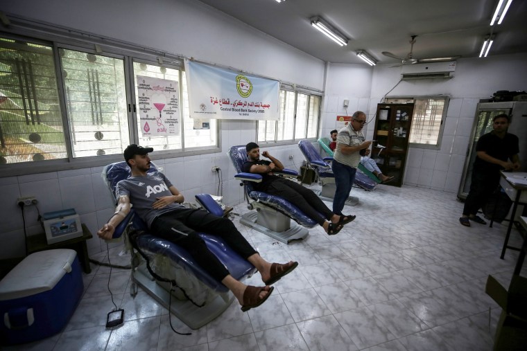 Men donate blood at the Central Blood Bank Society in Gaza City on Saturday.