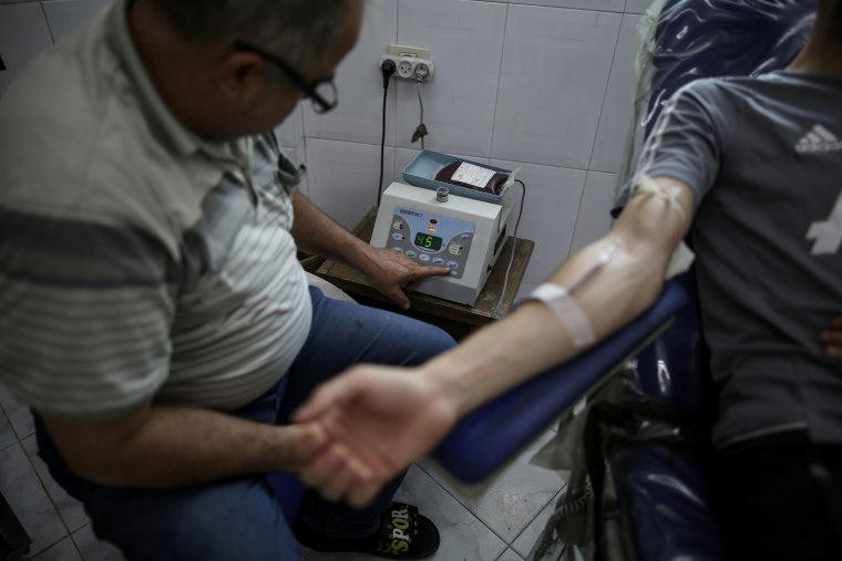 A man gives blood at the Central Blood Bank Society in Gaza City on Saturday.