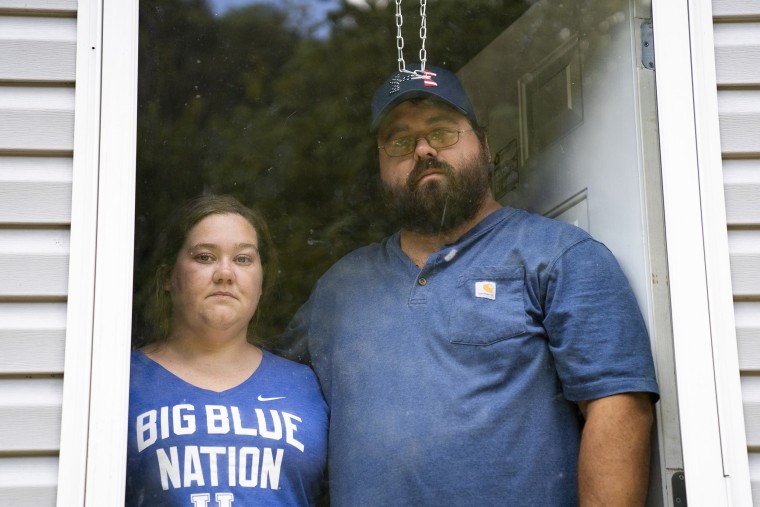 Image: Natasha Skidmore and Gregory Chase Hays in the front door of their house in the Upper River Caney community of Lost Creek, Ky., on Aug. 18, 2022.