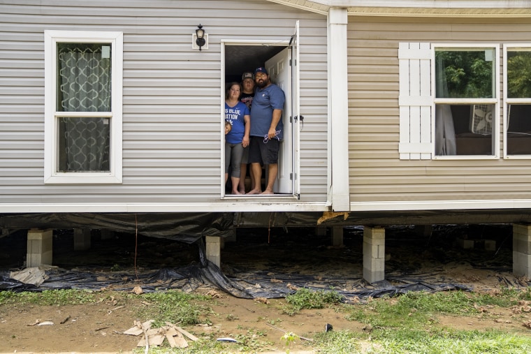 Image: Natasha Skidmore, Gregory Chase Hays, Brelyn Hays and Tatyn Skidmore  in the front door of their house in the Upper River Caney community of Lost Creek, Ky., on Aug. 18, 2022.