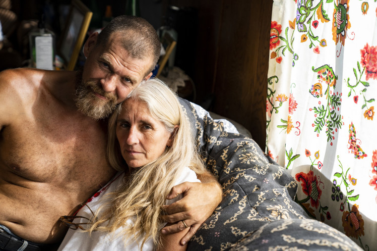 Image: Clay and Monica Fugate in Monica's late mother's home where they have been staying since their house flooded after the silt pond broke and flooded the River Caney community of Lost Creek on Aug. 18, 2022.