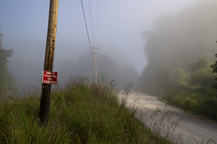 Image: A sign reading "Smile You're on Camera" at the entrance of a strip mine in Lost Creek, Ky., on Aug. 18, 2022.