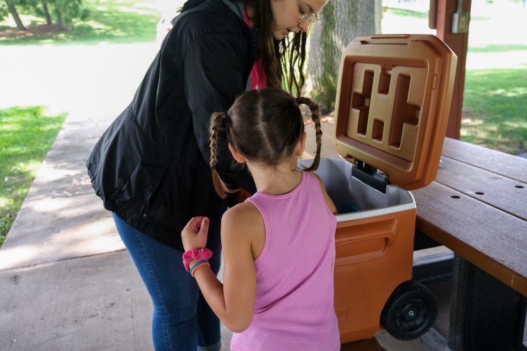 Image: Erin McAlvany's family receives meals at a meal site in Kirksville, Mo. on Aug.16, 2022.