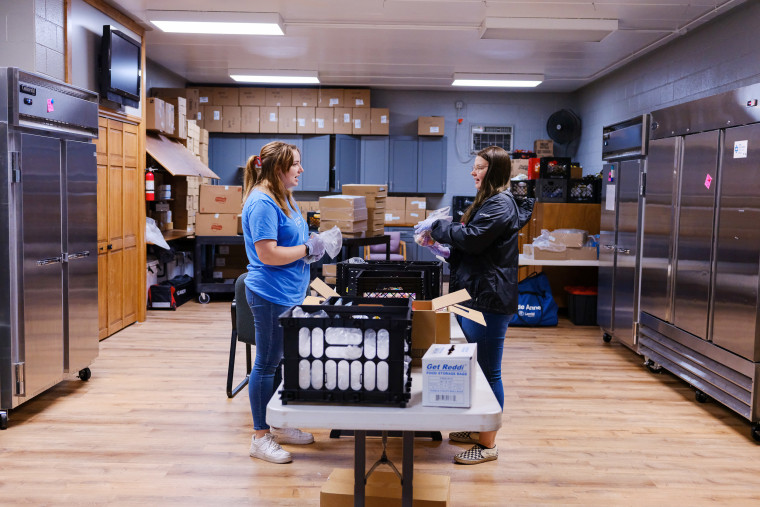 Image: Terri Martin and Shannon Bundridge pack the day's meals at the Adair County Family YMCA in Kirksville, Mo, on Aug.16, 2022.