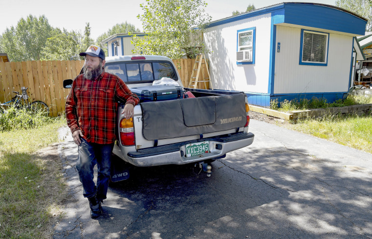 Sean Bailey stands outside the mobile home where he rents a room in Steamboat Springs.