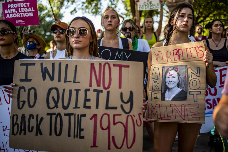 Protesters hold up signs during an abortion-rights rally on June 25, 2022, in Austin, Texas.