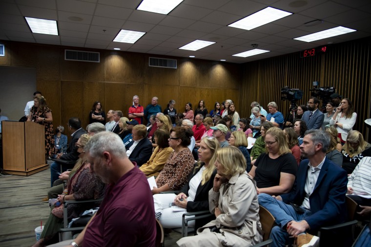Image: Attendees listen to a member of the public speak during a Grapevine-Colleyville Independent School District school board meeting in Grapevine, Texas on Aug. 22, 2022.
