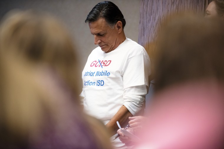 Karl Meek went to a Grapevine-Colleyville Independent School District board of trustees meeting Monday wearing a T-shirt with the district’s name, GCISD, crossed out and replaced with the words “Patriot Mobile Action ISD” to protest the political action committee’s influence over the school system.