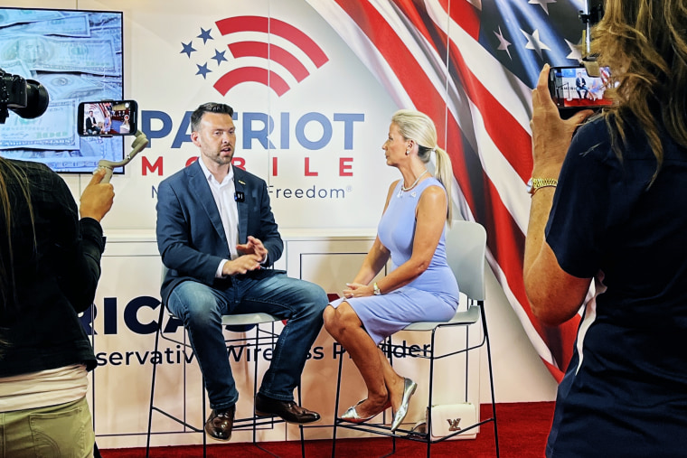 Leigh Wambsganss interviews pro-Trump conspiracy theorist Jack Posobiec at the Patriot Mobile booth at CPAC in Dallas on Aug. 4.