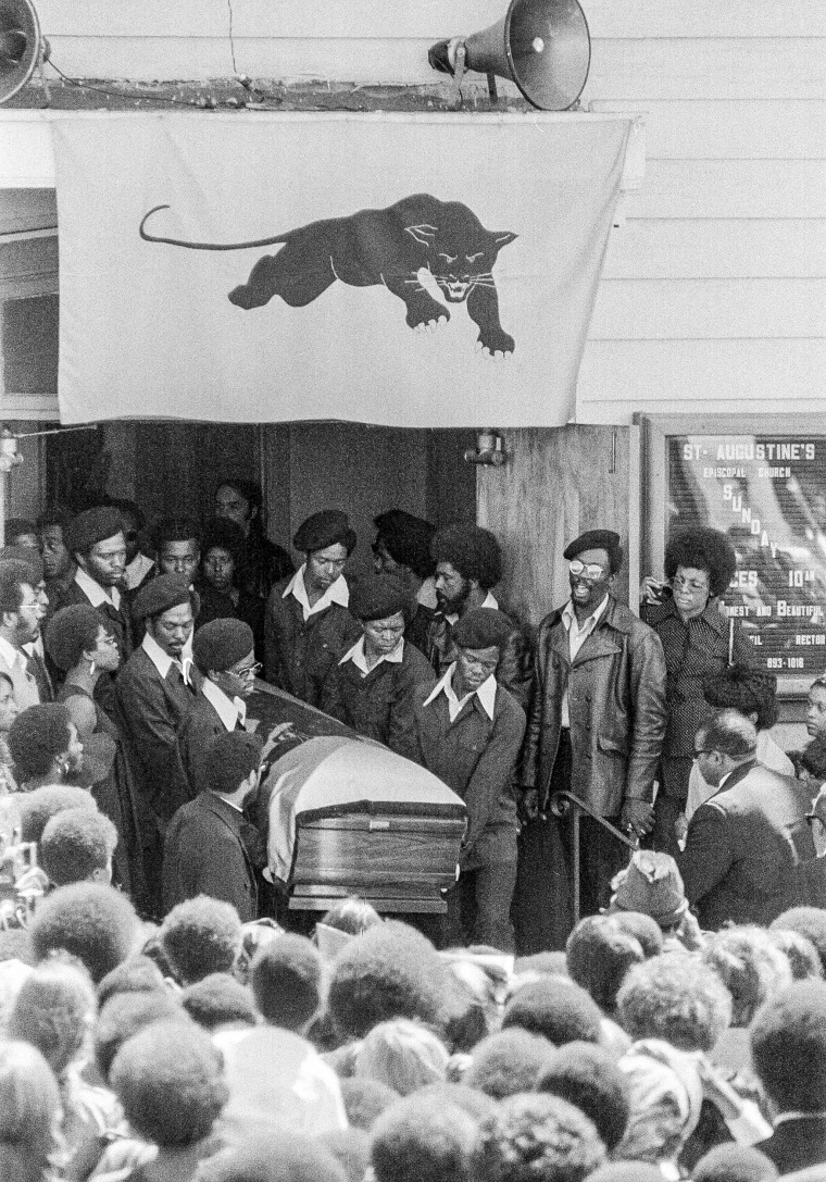 George Jackson's casket, draped in a blue flag with a Black Panther emblem, is carried from St. Augustine's Episcopal Church by six pall bearers in black berets, black suits and white gloves in Oakland, Calif., on Aug. 28, 1971.