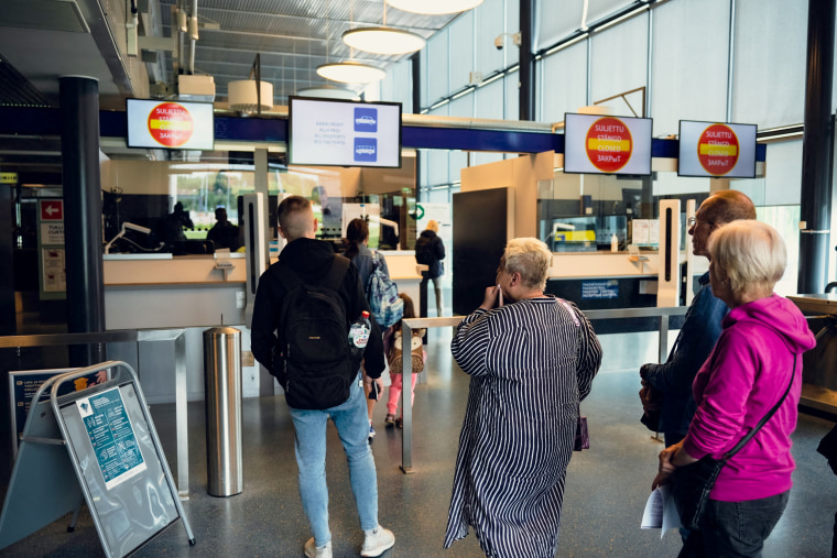 IMage: Russian tourists have their passports checked at the Nuijamaa border crossing in Finland on July 28, 2022.