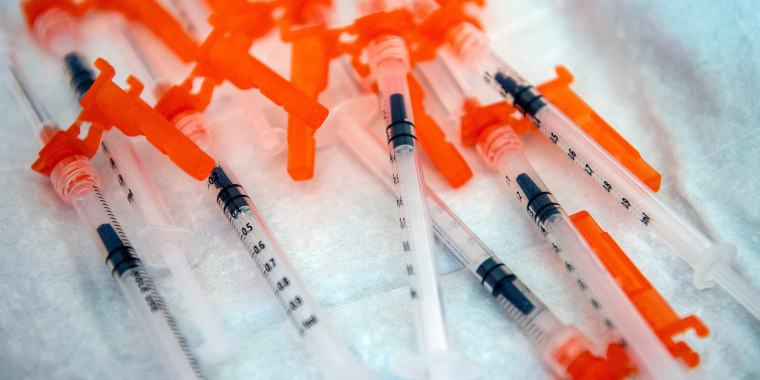 Image: Syringes on a table.
