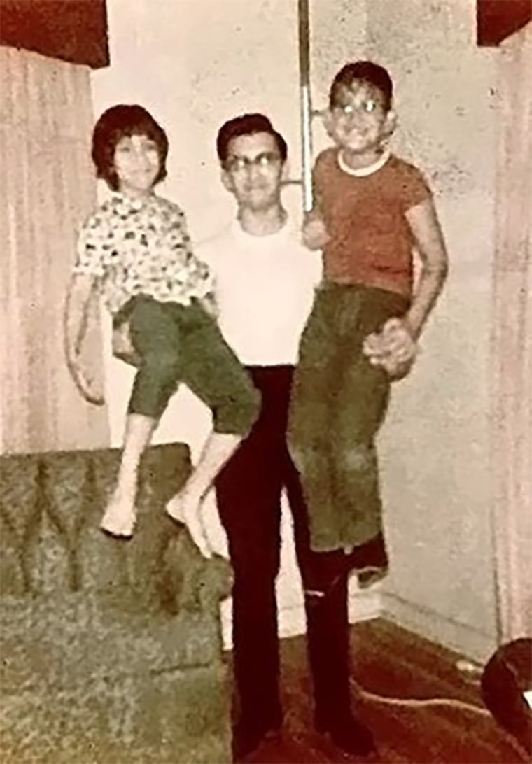 Rene Santos (about a year before his death) holding his younger siblings, Margaret, left, and Robert Santos.