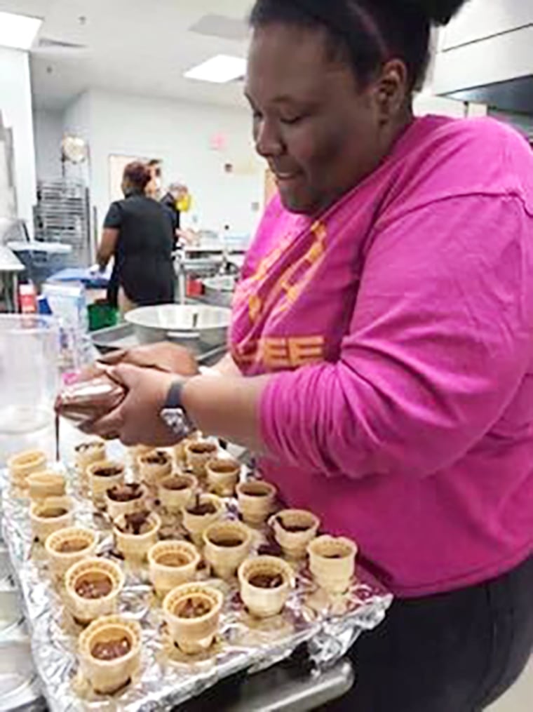 Saniyya Boykin fills dessert cones for a student celebration. 