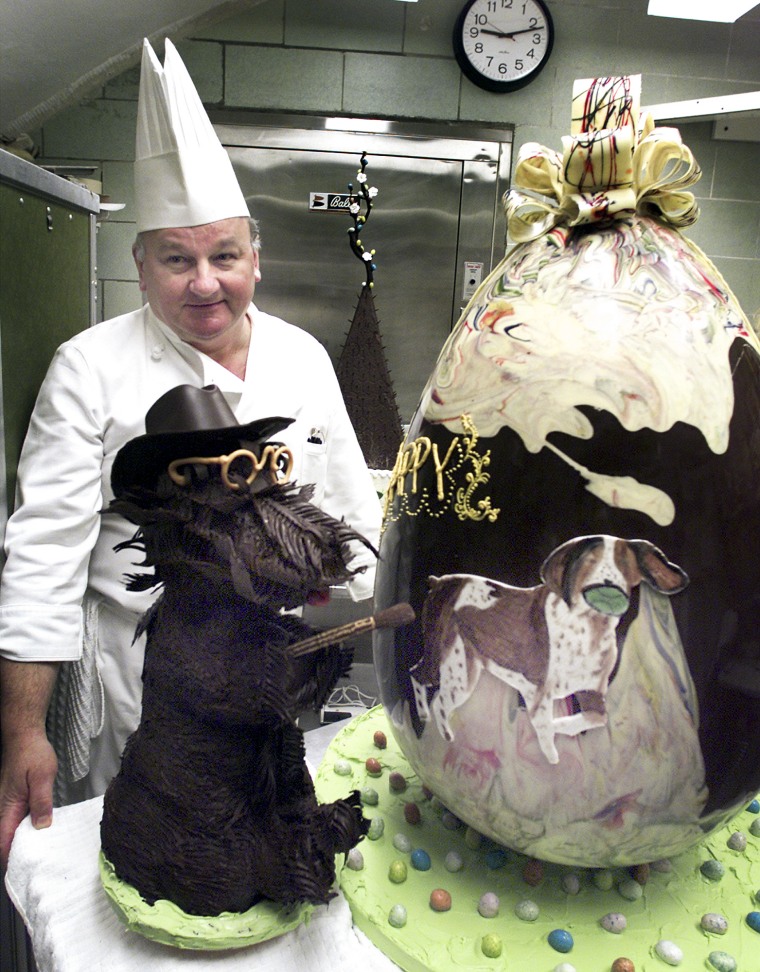 White House pastry chef Roland Mesnier shows off the 45 pound Easter egg and replica of Barney, the president's dog, in March 2002.