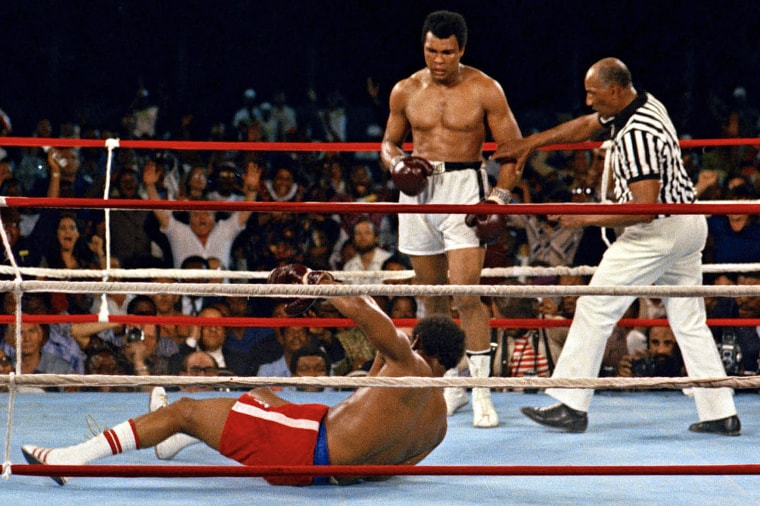 Referee Zack Clayton, right, steps in after challenger Muhammad Ali knocked down defending heavyweight champion George Foreman in the eighth round of their championship bout on Oct. 30, 1974, in Kinshasa, Zaire.