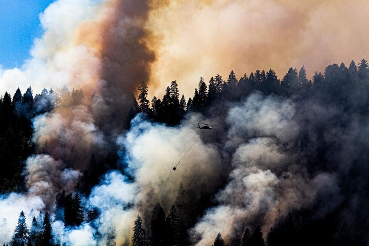 A helicopter flies over the Rum Creek Fire on Aug. 21, 2022.