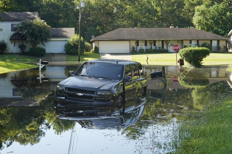 An SUV rests in floodwaters in northeast Jackson, Miss., on Aug. 29, 2022. 