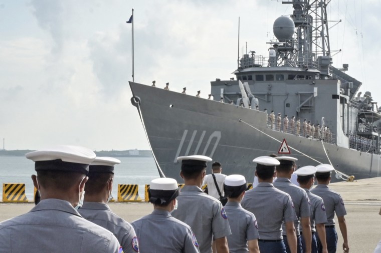 Navy soldiers walk in front of a frigate as President Tsai Ing-wen inspects military troops on Penghu Islands, Taiwan, on Aug. 30, 2022.