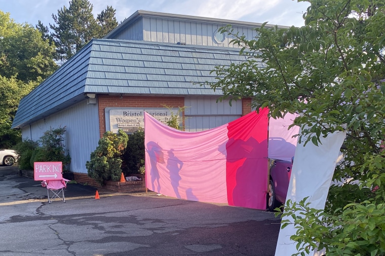 On the days Bristol Regional Women’s Center provides abortions, volunteers calling themselves the Pink Defenders show up to help shield patients from anti-abortion protesters by hanging sheets and posting signs around the parking lot.
