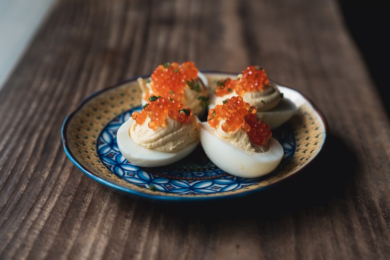 Fête's deviled eggs topped with smoked trout roe and chives.
