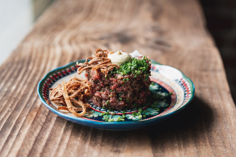Fête's Steak Tartare: Kua’aina Ranches beef, Mahiki veal, béarnaise aioli, crispy shallots, chives, and toast with anchovy butter.