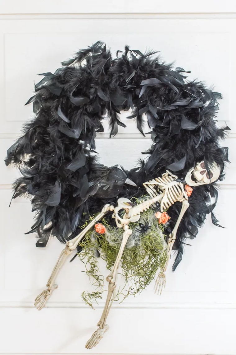 black feather wreath with skeleton