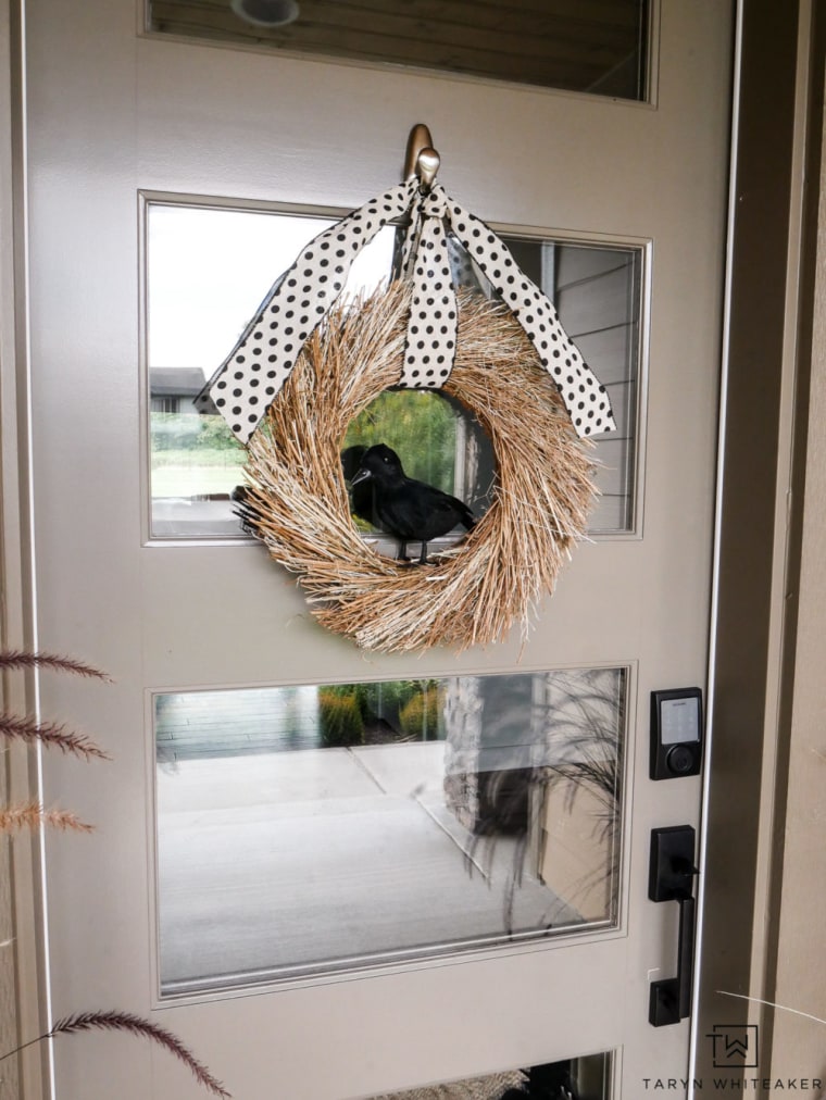 natural wreath with faux crow in middle