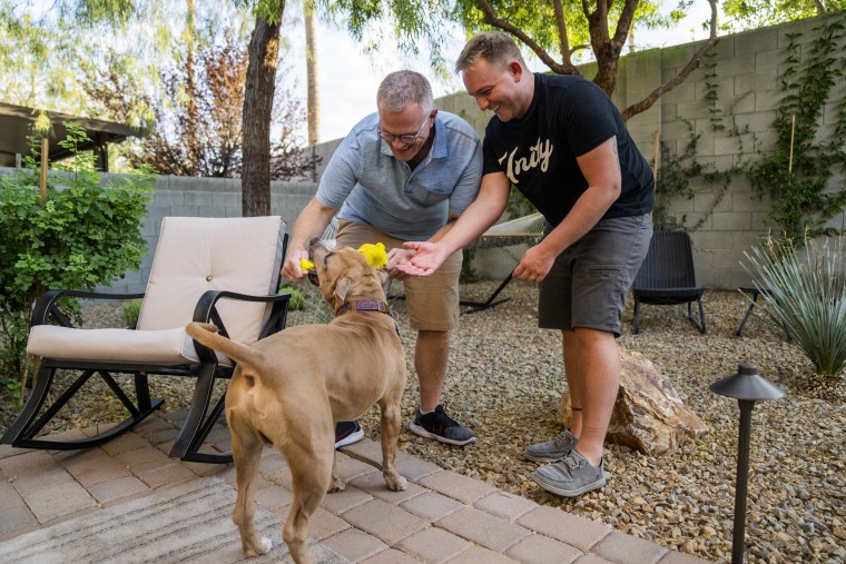 Ryan Hampton and Sean O’Donnell play with their dog, Bruno, at their Las Vegas home.