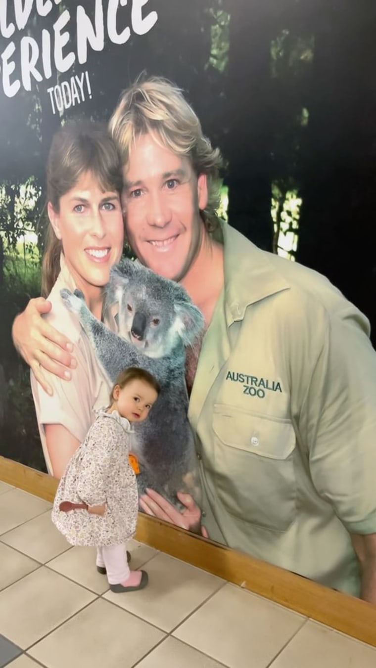 Grace Warrior poses with a photo of her grandparents at Australia Zoo.