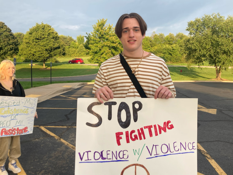 Gabe Moore, 17, protesting outside his high school in opposition of a Missouri school district's new corporal punishment policy.