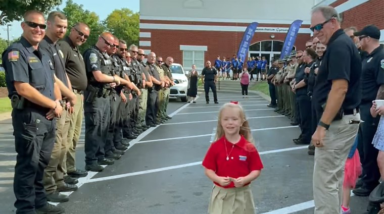 A kindergartner in Tennessee was escorted to her first day of school by members of her late father's police department.  
