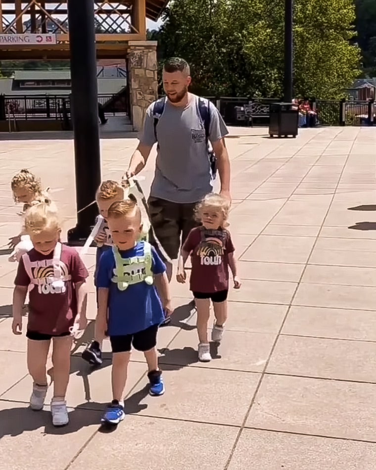 Kentucky dad Jordan Driskell leashes his quintuplets for family outings.
