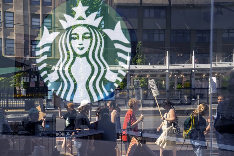 Unionized workers strike for unfair labor practices outside a Starbucks location in the Brookline neighborhood of Boston, Massachusetts, US, on Tuesday, July 19, 2022. 