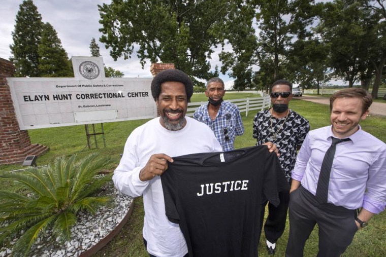 Sullivan Walter, 53, left, holds a shirt near Elayn Hunt Correctional Center in St. Gabriel, La., with, left to right, his brothers Corner Walter, Jr. and Byron Walter, Sr., and Innocence Project New Orleans legal director Richard Davis, just after his release on Thursday, Aug. 25, 2022.