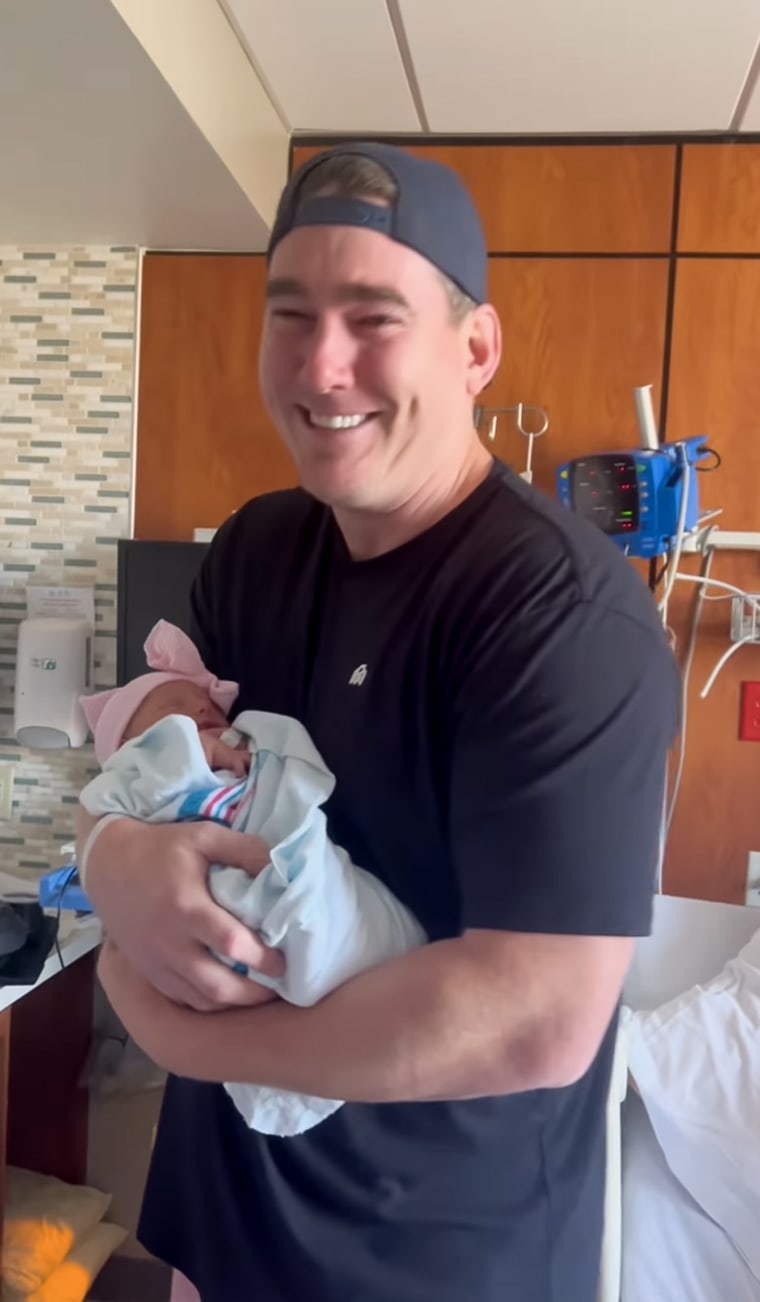 Tears flow as the new dad present his baby daughter, saying "She's pretty like mama."