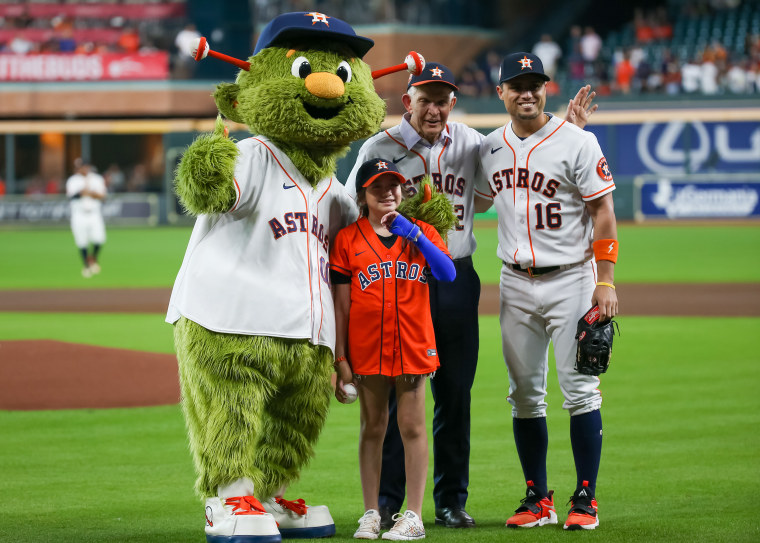 Houston Astros mascot Orbit, Uvalde mass shooting survivor Mayah Nicole Zamora, Gallery Furniture owner Jim Mattress Mac McVale and Houston Astros outfielder Aledmys Diaz pose during the MLB game between the Minnesota Twins and Houston Astros on Aug. 23, 2022 at Minute Maid Park in Houston, Texas.
