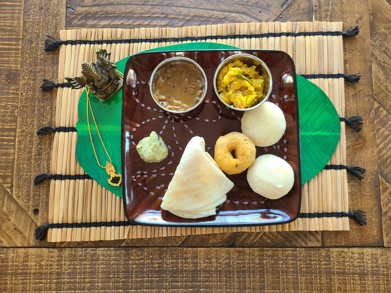 Dosa, idlis and a vada with chutney, sambar and masala.