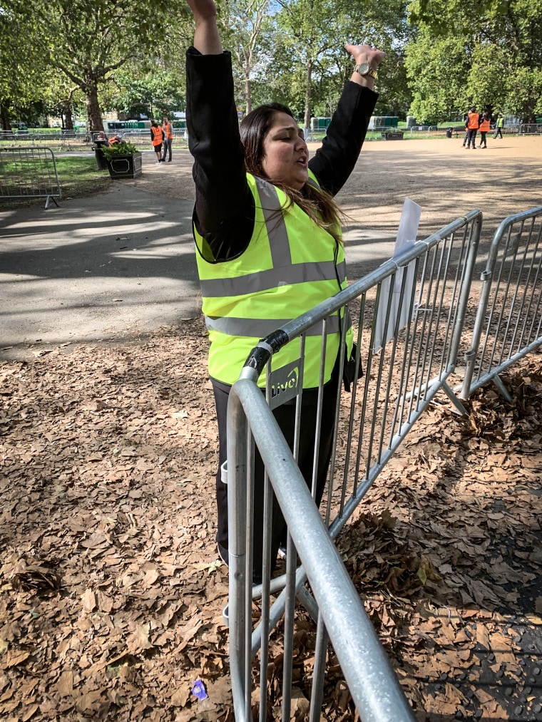 33-year-old steward Rabia Sheikh cheering on the line of people waiting to see the coffin of Queen Elizabeth II lying in state, on Sunday.