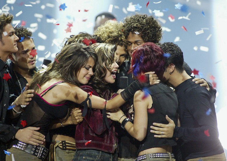 Image: American Idol winner Kelly Clarkson is embraced by Idol contestants at the Kodak Theatre on Sept. 4, 2002 in Hollywood, Calif.