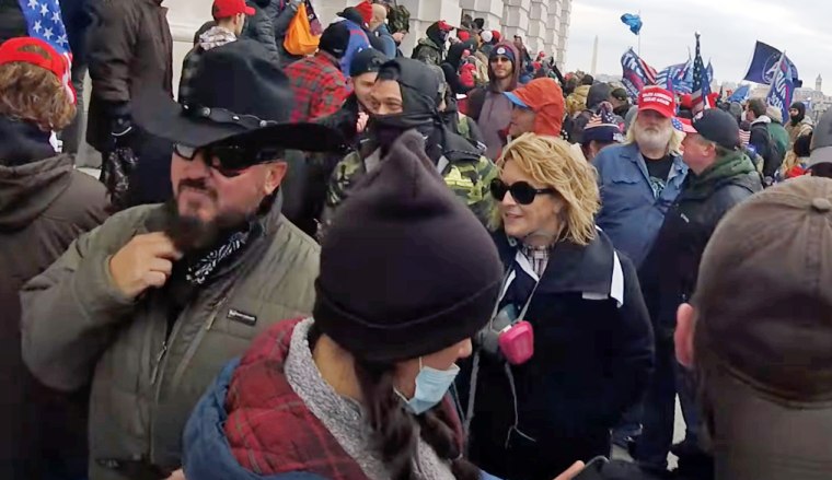 Stewart Rhodes, the founder of the Oath Keepers, left, and Kellye SoRelle, in sunglasses, at the U.S. Capitol on Jan. 6, 2021. 